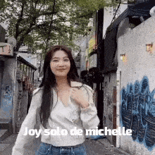 a woman is walking down a street with the words joy solo de michelle written on the bottom .