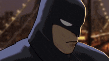 a close up of a batman 's face with a blurred background