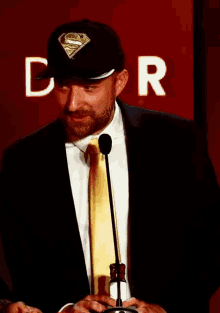 a man wearing a superman hat and tie
