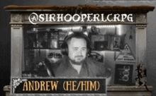 a man wearing headphones is behind a sign that says andrew he him