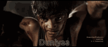 two men are standing next to each other and the word duniyaa is on the bottom right