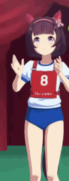 a girl is wearing a number 8 vest