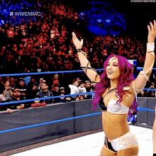 a woman in a wrestling ring with the hashtag #wwemmc on the bottom right
