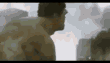 a man is standing in front of a building in a blurred image .