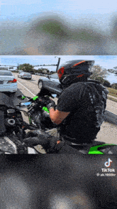 a man wearing a helmet is riding a motorcycle on a street