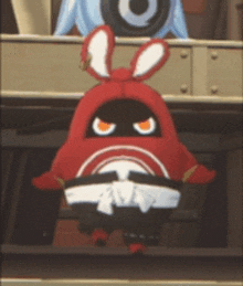a red cartoon character with bunny ears and a karate belt