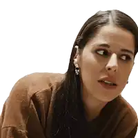 a woman wearing a brown sweater and earrings looks to the left