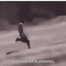 a person is running in the snow with the words `` nahh im running '' written below them .