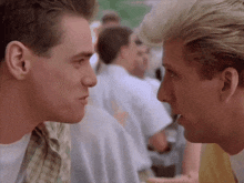 two men are looking at each other with their mouths open .