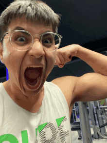 a man wearing glasses and a tank top that says ok