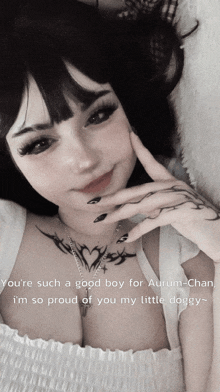 a girl with a tattoo on her chest says you 're such a good boy for aurum chan