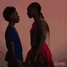 a couple of people standing next to each other with the showtime logo in the background