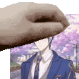 a man in a suit and tie is being patted by a hand .