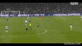 a soccer game is being played and the goalie is wearing the number 12