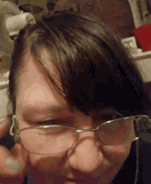 a close up of a person wearing glasses with a blurred background