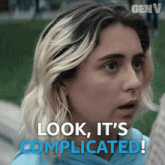 a close up of a woman 's face with the words look it 's complicated behind her