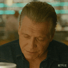 a close up of a man 's face with netflix written on the bottom