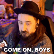 a man with long hair and a beard is sitting in a chair and says come on boys