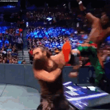 a wrestling match is going on in front of a crowd and the hashtag #thenextbigthing is on the screen