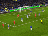 soccer players on a field with a banner that says etoro on the sidelines