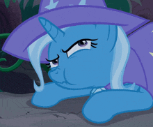 a blue cartoon pony wearing a purple hat with a star on it