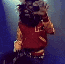 a person wearing a varsity jacket with the letters lm on it