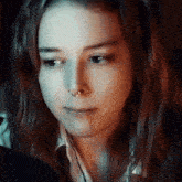 a close up of a woman 's face with a nose ring on