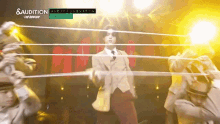 a man in a suit and tie is dancing in front of a sign that says something