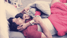 a man and woman are laying on a bed with a blanket that says vivo