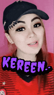 a woman wearing a hat and a red shirt with the word kereen written on it