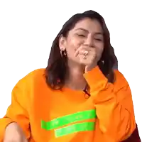 a woman wearing an orange sweatshirt with the word vogue on it