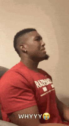 a man is wearing a red shirt that says whyyy