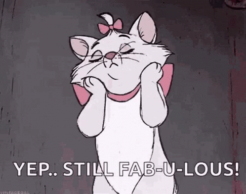 GIF animation with white cat touching her cheeks and the words "yep, still fabulous" at the bottom