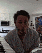 a man in a white shirt is making a funny face