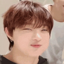 a close up of a young boy making a funny face .