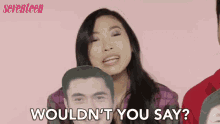 a woman is holding a cardboard cutout of a man 's face and asking wouldn 't you say