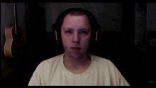 a man wearing headphones looks at the camera