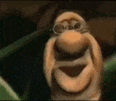 a close up of a cartoon character wearing glasses and making a face .