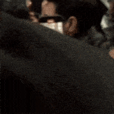 a blurry picture of a group of people talking to each other in a room .