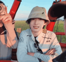 a man wearing a bucket hat with the letter hh on it