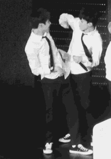 a man is holding another man in his arms and they are hugging