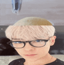 a close up of a person 's face with glasses and blonde hair