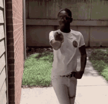 a young man wearing a white shirt with the letter f on it