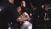 a man is carrying a woman in his arms and the word zeus is visible in the corner