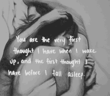 a black and white drawing of a man hugging a woman with a quote written below it