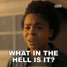 a young girl is making a funny face and says what in the hell is it