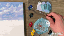 a person is painting on a canvas with the words made in animatica visible