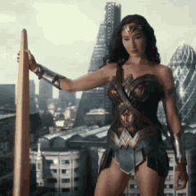 a woman in a wonder woman costume is holding a sword