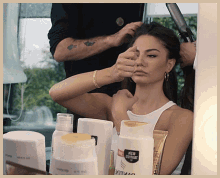 a woman is getting her hair done in front of a bottle that says pantene