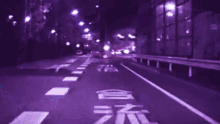 a blurry picture of a road with a purple background